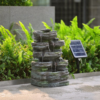 Faux rock garden fountain with lights, stacked tier design with flowing water streams.