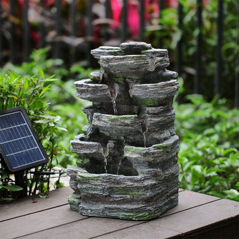 Faux rock garden fountain with integrated solar lights and fountain water streams.