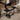 Charcoal BBQ grill open with cooking grates, side shelves, and warming rack