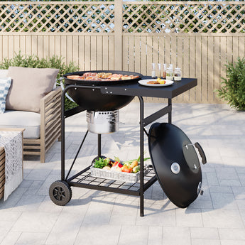 Round charcoal grill with side table, lid closed, vegetables on lower rack