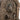 Stone-look fountain close-up of carved seated figure within the arch
