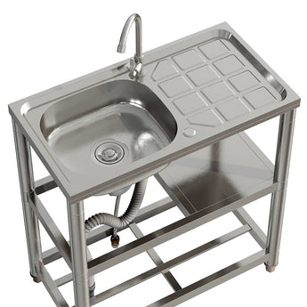 Top view: single stainless sink basin with faucet and tiled drainer area