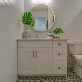 Round bathroom wall mirror with gold frame and clear reflective glass