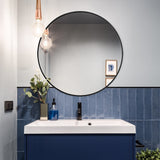 Round bathroom mirror with black metal frame and clear reflective glass
