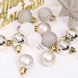 Assorted Christmas baubles in white, silver, and gold with shiny clip tops