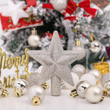 Glitter star tree topper with assorted white, silver, and gold Christmas ornaments