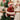 Plush snowman Christmas ornament with red plaid outfit and tan trim