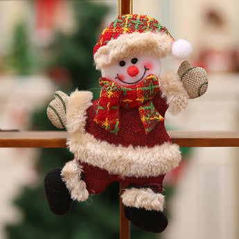 Plush snowman Christmas ornament with red plaid outfit and tan trim