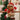 Plush bear Christmas ornament with plaid scarf and red heart accents