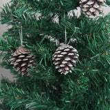 Pine cone hanging ornament with white-painted scales on green Christmas tree branches