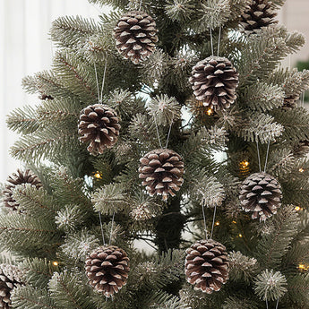 Hanging pine cone ornaments with white-painted tips and dark pine-brown cones