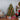 Wooden hanging ornament set on decorated tree with red accents and warm lights