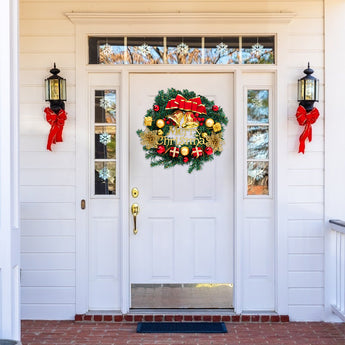 Christmas wreath featuring green foliage, gold bells, red bow, and red and gold baubles