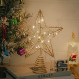 Lighted metal star tree topper with warm white bulbs on a spiral stand