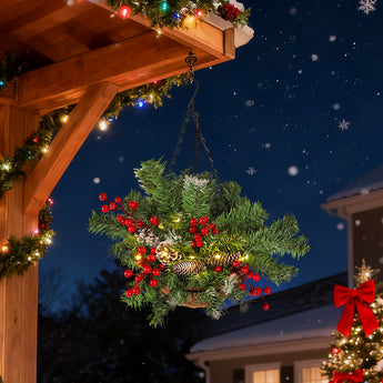 Pre-lit Christmas hanging basket with pine greenery, red berries, pine cone, warm lights