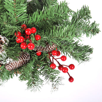Artificial pine branch sprig with red berries and frosted pine cones