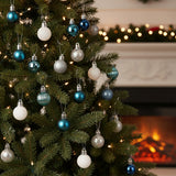 Christmas ball ornaments hanging on tree branches: white, silver glitter, and blue baubles