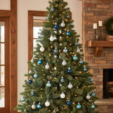 Christmas ball ornaments on tall tree: white, silver, and blue hanging baubles