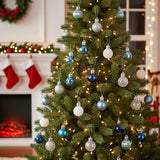 Christmas ball ornaments on tree: blue, white, and silver spherical baubles with caps