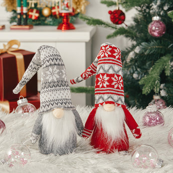Christmas gnome plush ornaments, red and grey striped hats with long white beards.