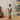 Christmas nutcracker soldier figurine with white beard, black hat, green pants, holding a sword