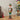 Christmas nutcracker soldier figurine with white beard, green crown, red and gold jacket, holding baton