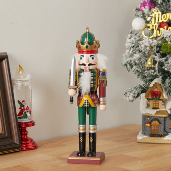 Christmas nutcracker soldier figurine with white beard, green crown, red and gold jacket, holding baton
