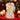 Cream angel tree topper in gold-patterned dress with white feather wings