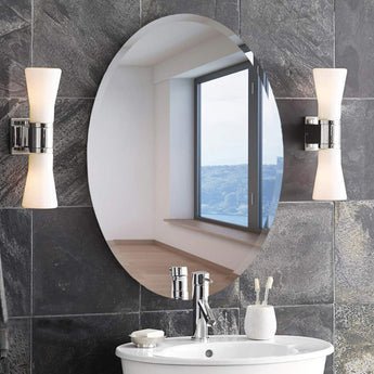 Oval frameless wall mirror with slim silver edge border and reflective surface