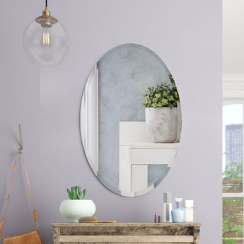 Oval frameless wall mirror with smooth slim border and reflective glass