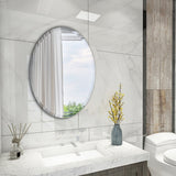 Oval, wall-mounted frameless mirror with smooth reflective glass