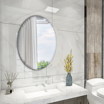 Oval, wall-mounted frameless mirror with smooth reflective glass
