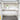 White expandable closet shelf with hanging rod and lower storage platform