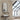 Black oval wall mirror with rounded arch frame, hanging above a bathroom sink.