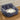 Dark gray cozy dog car seat bed with plush cushion base and logo patch