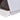 Corner detail of enclosed cat litter box with side vents and open-base access slot.