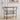 Metallic bar cart on wheels with three wood shelves and curved wine glass holder rack