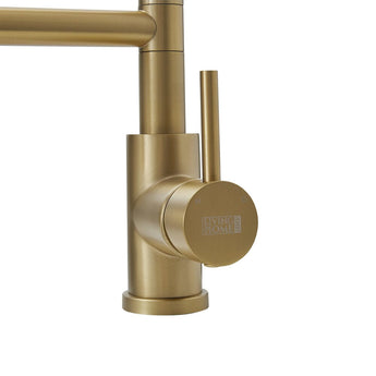 Brushed gold kitchen faucet close-up of control valve and side spout
