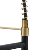 Gold kitchen faucet detail: arched spring hose beside black handle base