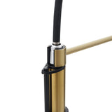 Gold faucet spout and black collar detail with textured hose connection