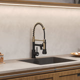 Gold and black kitchen faucet with pull-down sprayer over undermount sink