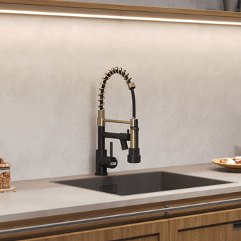 Gold and black kitchen faucet with pull-down sprayer over undermount sink