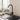 Black single-handle bar kitchen faucet with curved spout and round side control