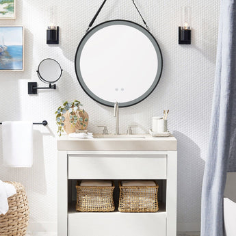 Round LED mirror with black outer frame, suspended by hanging strap