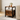Brown bedside table with black metal frame, one drawer and open lower shelf