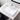 Rectangular marble vessel sink with round drain hole and glossy white surface