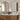 Set of two arched mirrors with black frames above a marble countertop