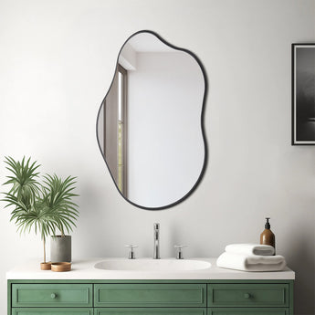 Irregular wall mirror with dark metal frame, rounded shield shape