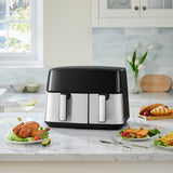 Dual basket air fryer on countertop with two front handles and black touchscreen