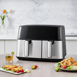 Dual basket air fryer front view with two metal baskets and glossy black top
